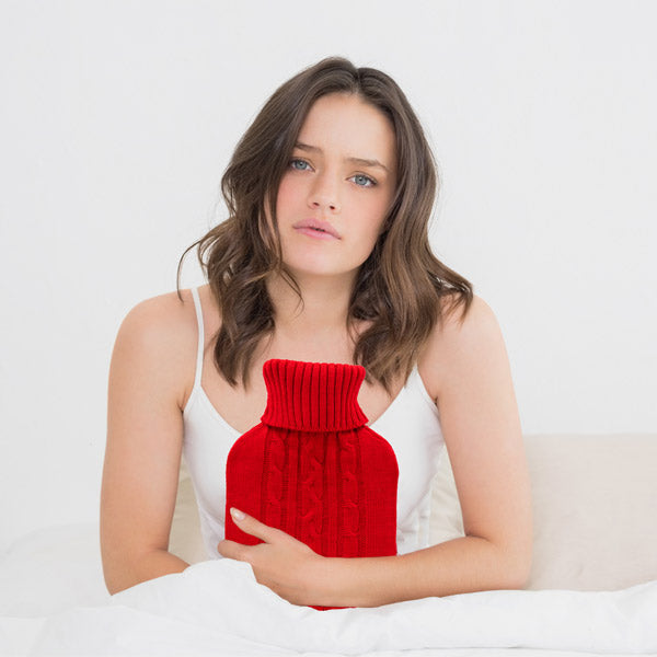 bouillotte axion avec housse en tricot rouge et motif torsadé
